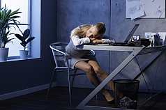 Frau schläft im Büro 