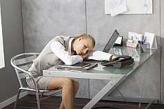 junge Frau ist erschöpft im Büro